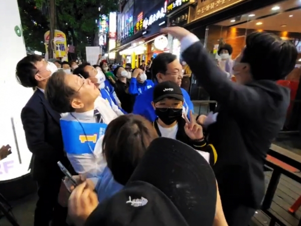 더불어민주당 이재명 인천 계양을 국회의원 후보가 철제그릇이 날아온 곳을 바라보고 있다. (사진=이재명 유튜브 채널 캡처)