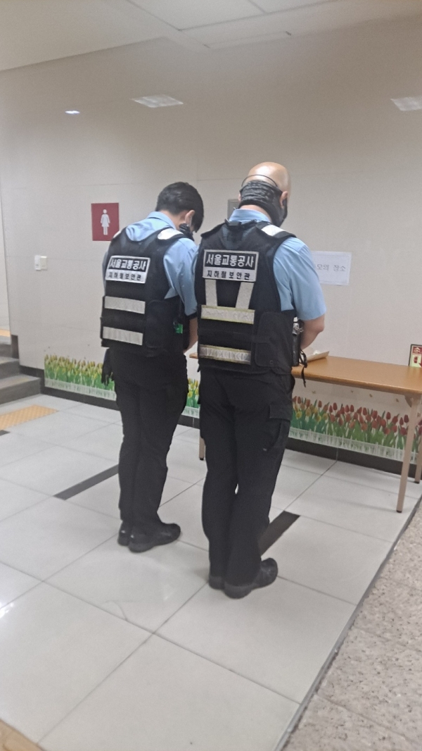 서울교통공사 지하철 보안관 두 명이 신당역에 조성된 추모의 공간에서 14일 스토킹·보복범죄로 살해된 여성 역무원에 대한 추모를 하고 있다. ⓒ여성신문