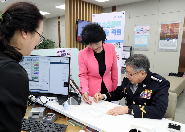 16일 김종욱 해양경찰청장이(사진 오른쪽)이 박서연 송도국제신도시 수협은행 지점장으로부터 상품가입 안내를 받으며 약정에 서명하고 있다.  ⓒ해양경찰청