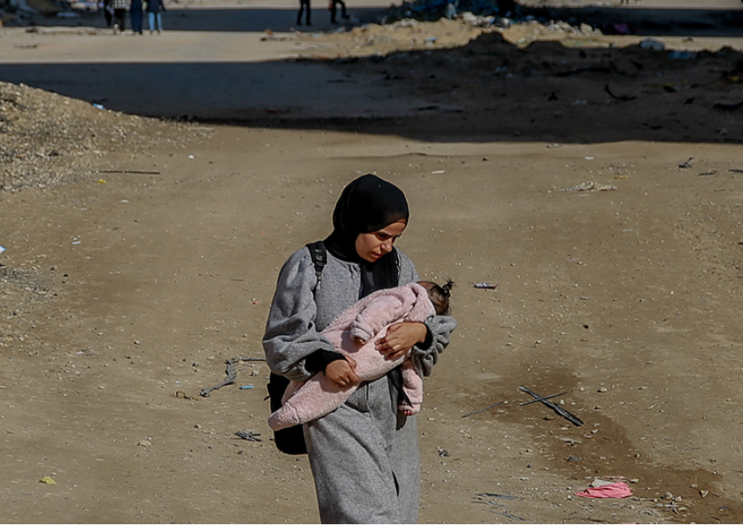 올해 29세인 팔레스타인 여성 살마가 아기를 안고 가자시티 서쪽의 라시드 거리를 걷고 있다. ⓒ유니세프/유엔 여성기구