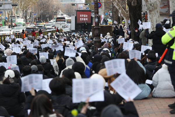지난해 12월 27일 오후 서울 종로구 혜화역 4번출구 인근에서 열린 '민주없는 민주동덕' 집회 참석자들이 손팻말을 흔들고 있다. ⓒ연합뉴스