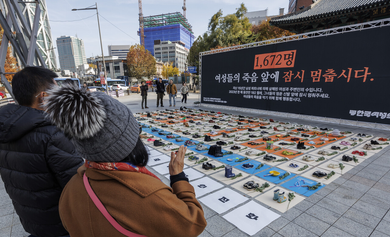 세계 여성 폭력 추방 주간을 맞이해 한국여성의전화가 2024년 11월 25일 서울 종로구 보신각 앞에서 개최한 여성 살해를 규탄 퍼포먼스를 관광객들이 지켜보고 있다. ⓒ연합뉴스