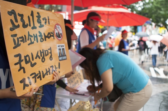 서울 중구 명동에서 한국YWCA연합회 회원들이 시민들을 상대로 탈핵과 탈원전 캠페인을 펼치는 가운데 한 시민이 서명을 하고 있다. ⓒ이정실 여성신문 사진기자