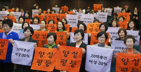 2015년 12월 15일 국회에서 여성단체들이 여성 30% 실현을 위한 범여성계 결의대회를 열어 구호가 담긴 스카프를 펼치고 있다.