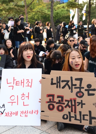 15일 서울 종로구 보신각 앞에서 열린 ‘나의 자궁, 나의 것-낙태죄 폐지를 위한 여성들의 검은 시위’에서 참가자들이 낙태금지법을 반대하는 피켓을 들고 구호를 외치고 있다. ⓒ뉴시스·여성신문