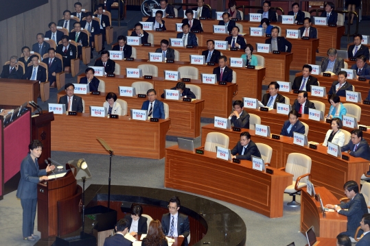 27일 서울 여의도 국회 본회의장에서 박근혜 대통령이 2016년 예산안에 대한 시정연설을 하고 있는 가운데 새정치민주연합 의원들은 국정교과서 반대 문구가 적힌 인쇄물을 노트북컴퓨터에 붙여 항의표시를 하고 있다.